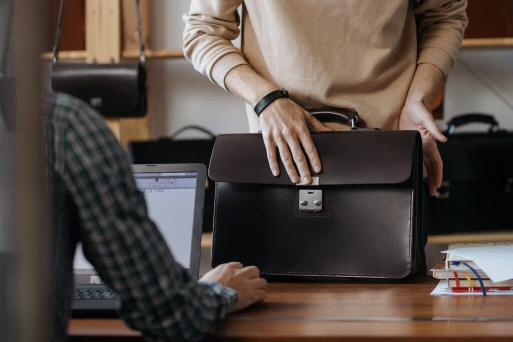 Business professional carrying black laptop bags in an office setting