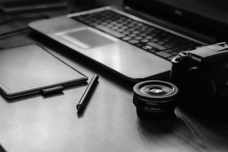 Black laptop bags placed beside a laptop on a modern office desk