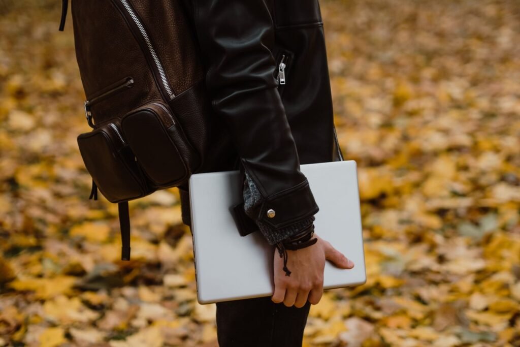 Student carrying black laptop bags on a university campus