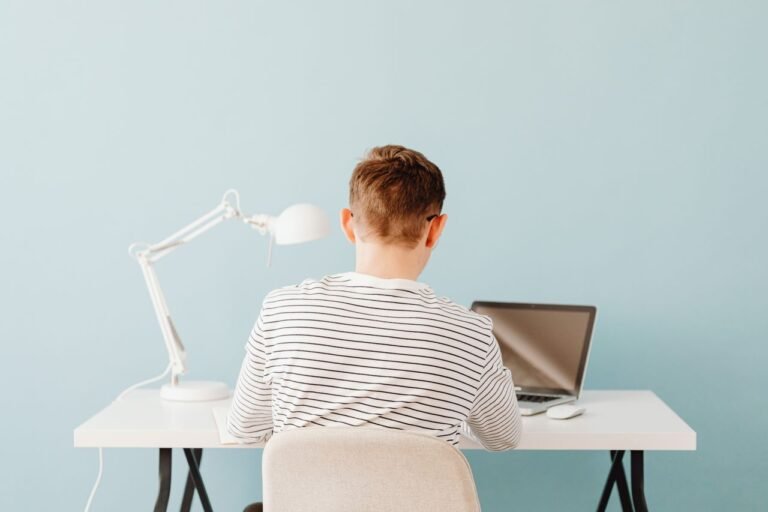 Best HP laptop charger for students beside a laptop study setup