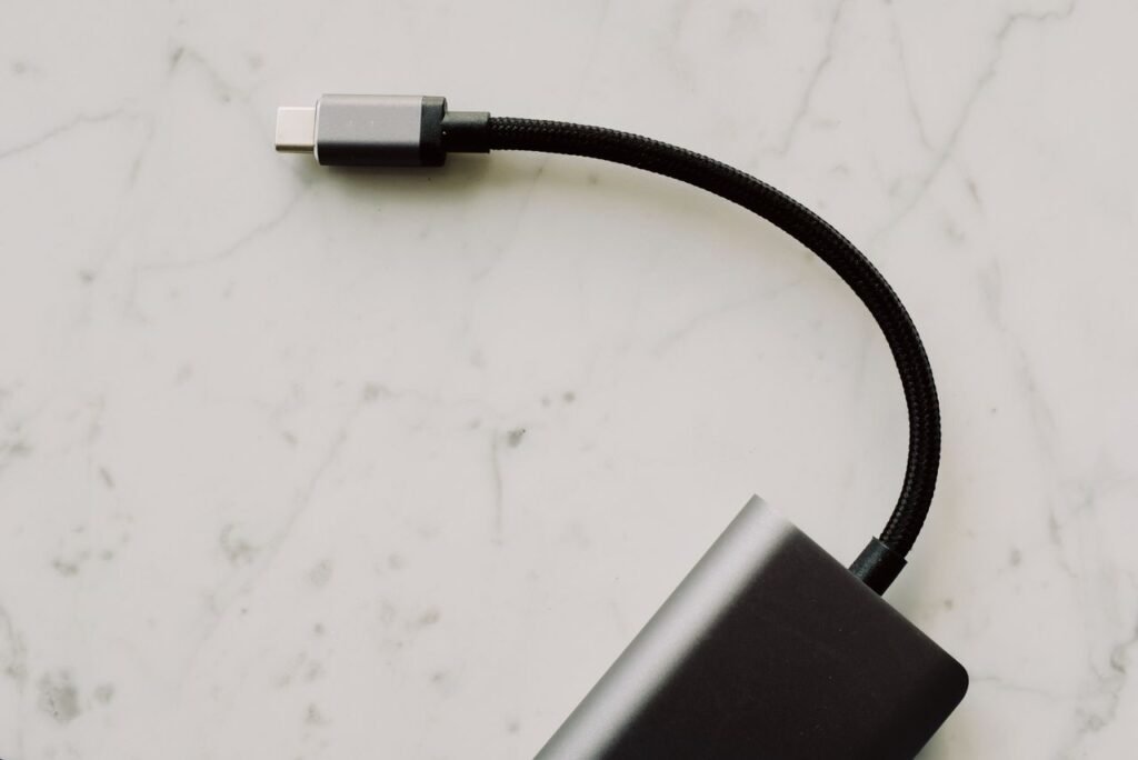 USB-C laptop charger connected to a modern laptop charging port