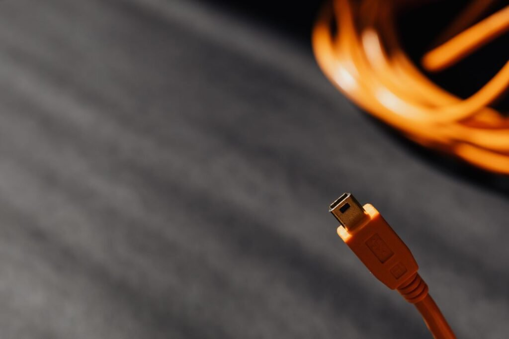 Damaged laptop charger cable showing signs of replacement